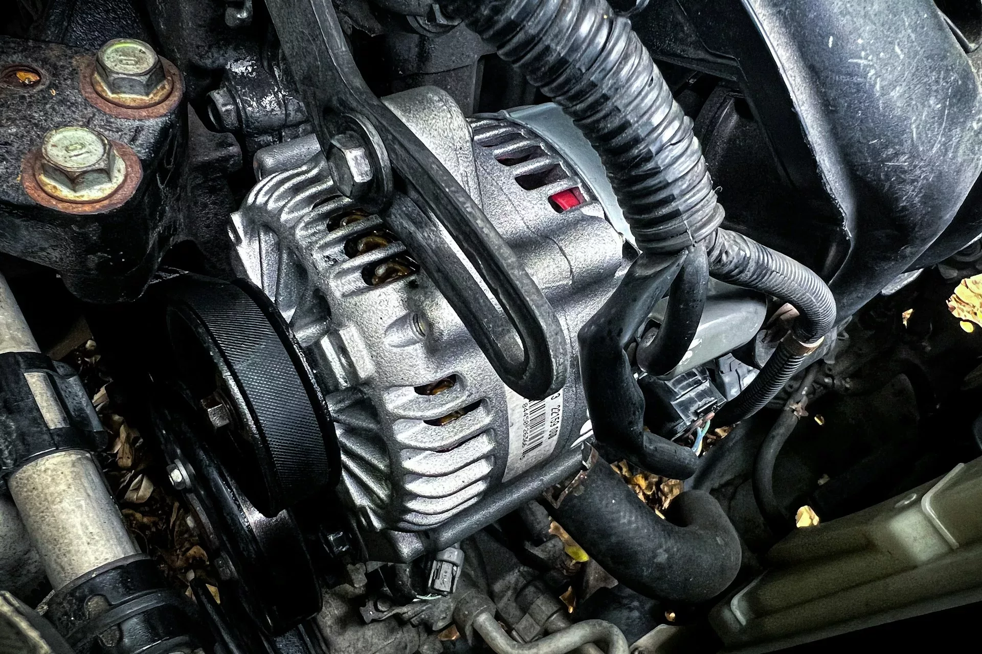 Alternator attached to car engine during inspection – alternator repair in Calgary, AB