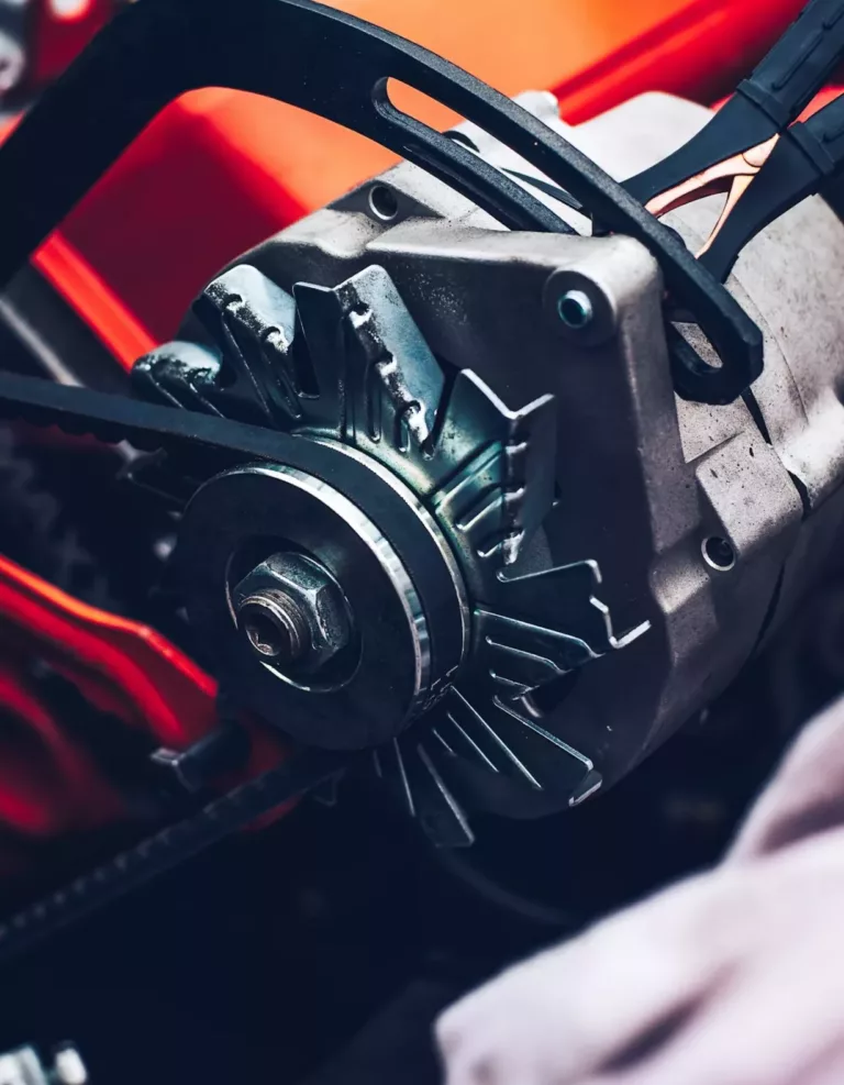 Close-up of automotive alternator with serpentine belt – Calgary alternator repair service