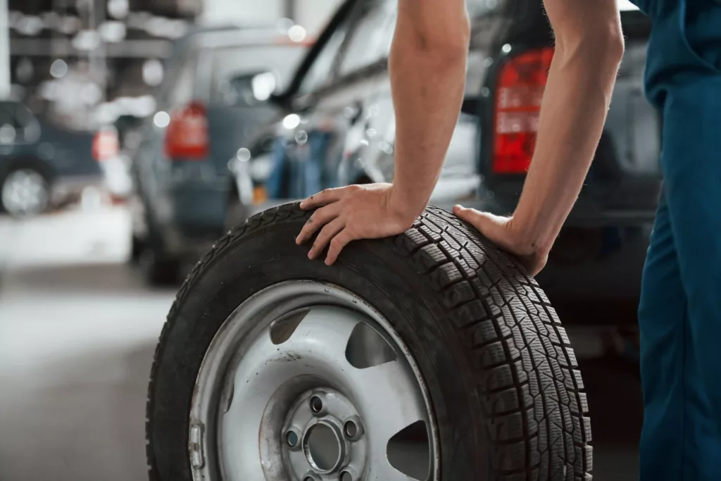 mechanic handling a tire in Calgary, AB